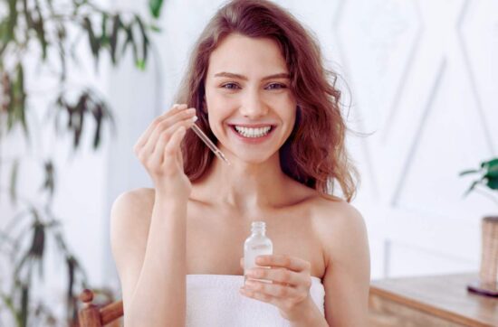 Kobieta stosuje serum z retinolem w pielęgnacji domowej